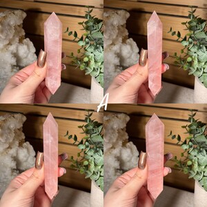 May include: Four images of a pink rose quartz crystal point. The crystal is a pale pink color and has a pointed top. The crystal is held in a hand. The background includes greenery and a wooden surface.