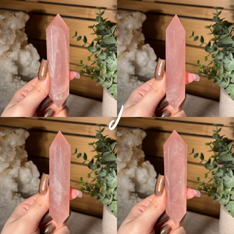 May include: Four rose quartz crystal points, each held in a hand. The crystals are a soft pink color and have a pointed top. The background includes greenery and a wooden surface.