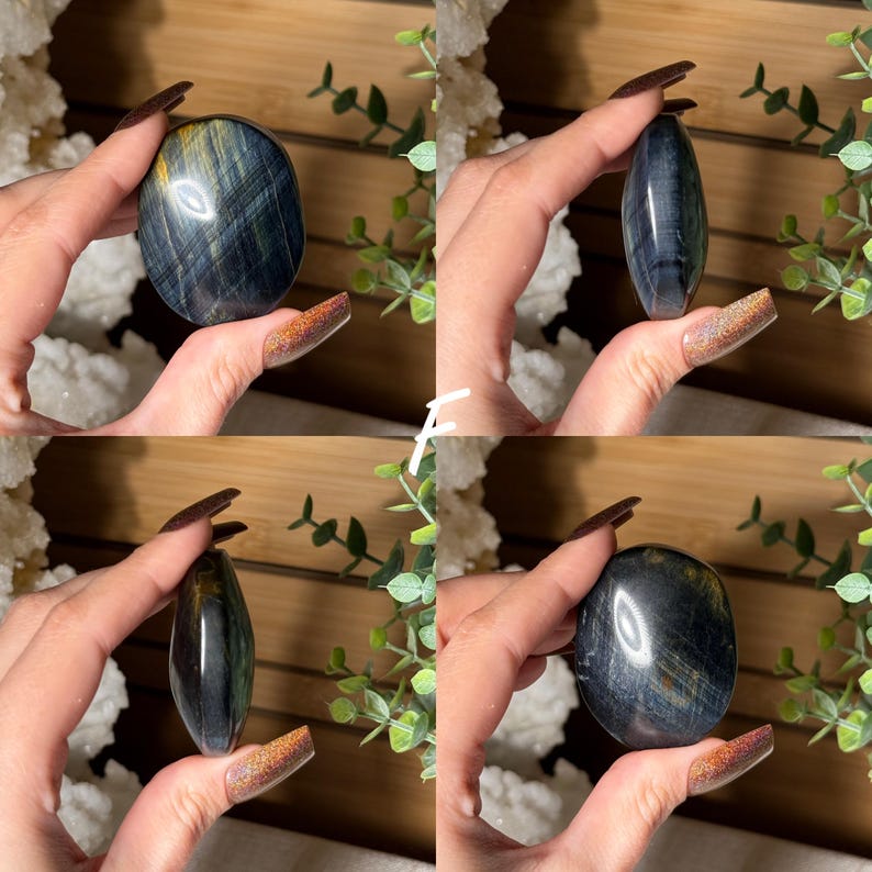 May include: Four images of polished blue tiger's eye stones. The stones are held in a hand, showcasing their oval and elongated shapes. The stones have a mix of blue, gold, and black colors, with a polished, reflective surface.