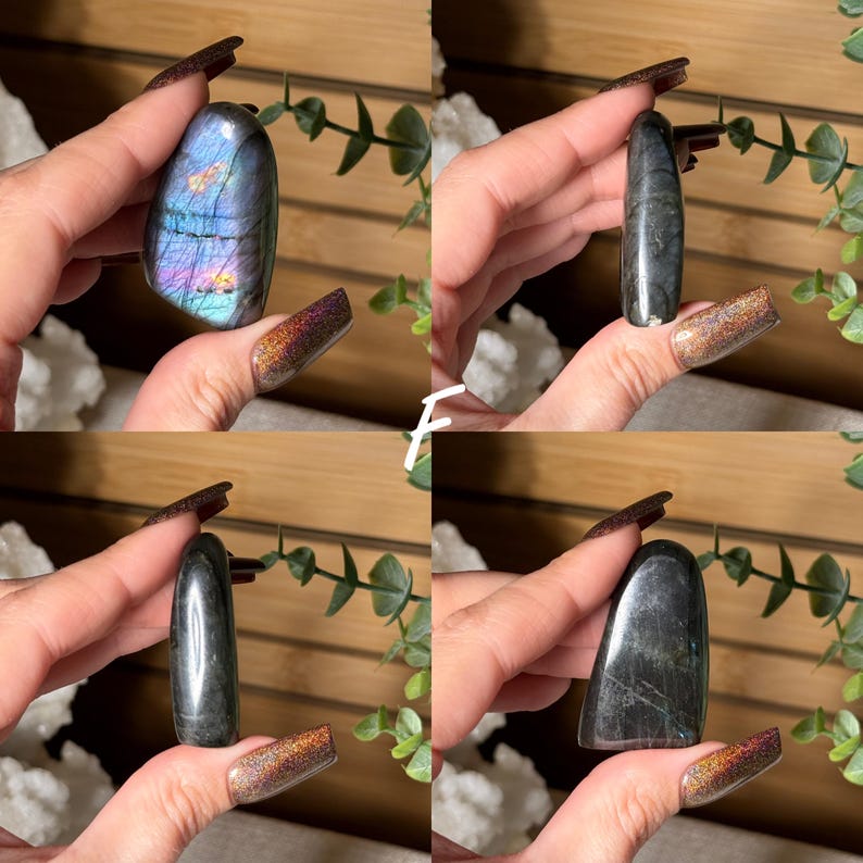 May include: Four images of polished gemstones. One is a blue, purple, and gold labradorite. The other three are dark gray stones with a smooth, polished finish. The stones are held in a hand with long, dark nails.