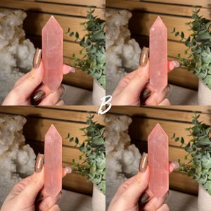 May include: Four rose quartz crystal points, each with a polished, faceted design. The crystals are a soft pink color and are held up against a wooden background with greenery and a white crystal formation. The letter "B" is in the center.