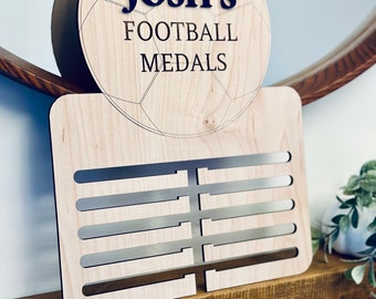 Personalised wooden medal holder for football or rugby players.