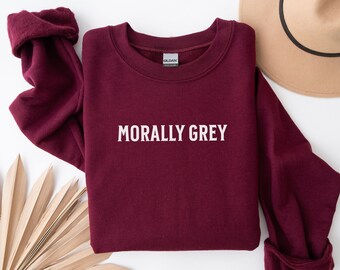 May include: Burgundy sweatshirt with the text "Morally Grey" printed in white on the front.