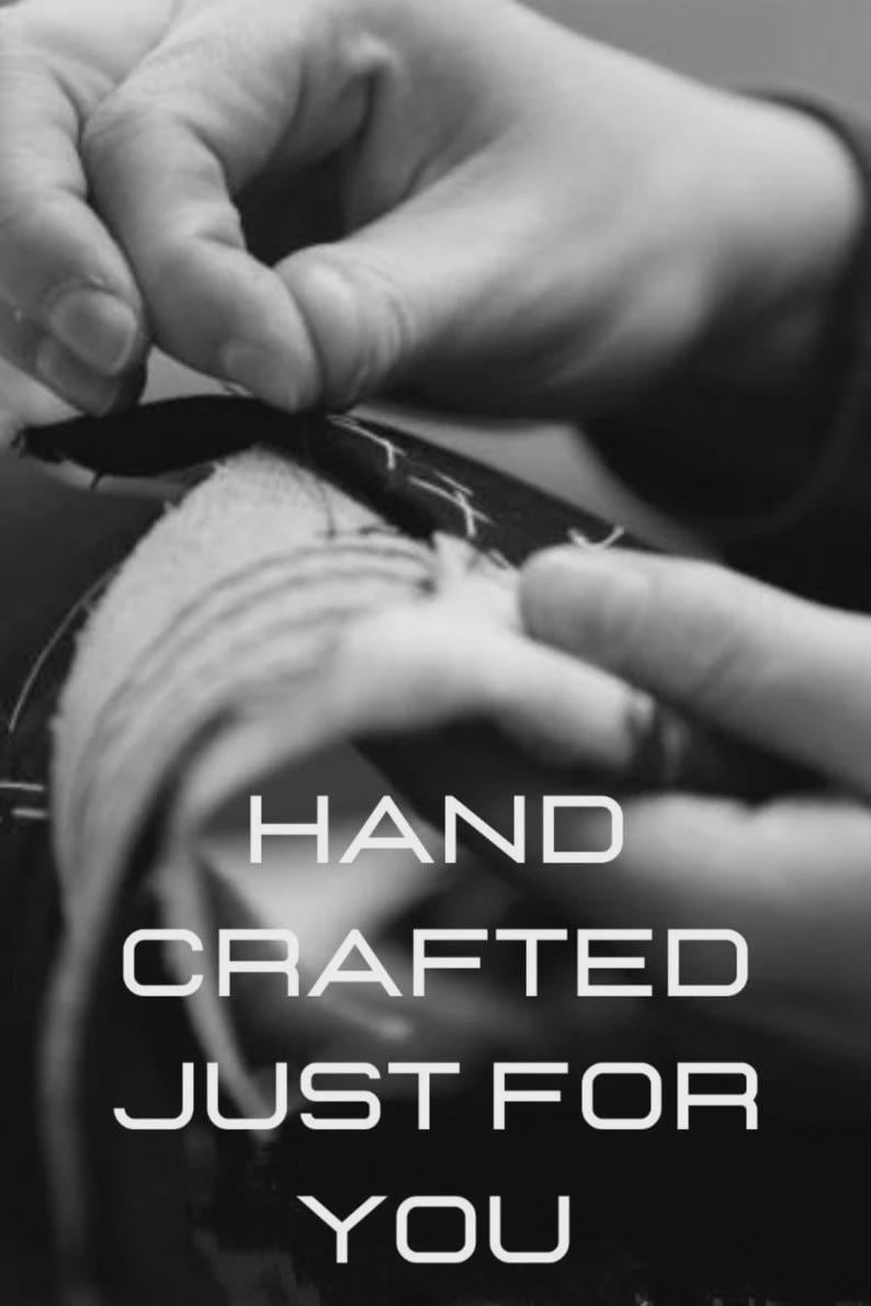 May include: Black and white image of hands sewing fabric. The text "HAND CRAFTED JUST FOR YOU" is displayed in a bold, white font. The image highlights the craftsmanship and care put into handmade items.