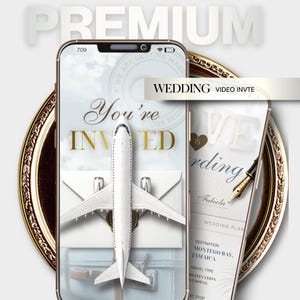 May include: A digital display showing a wedding video invitation with a white airplane model over an envelope and luggage. The screen features the text You're INVITED, WEDDING VIDEO INVTE, and details for a destination wedding in Montego Bay, Jamaica.