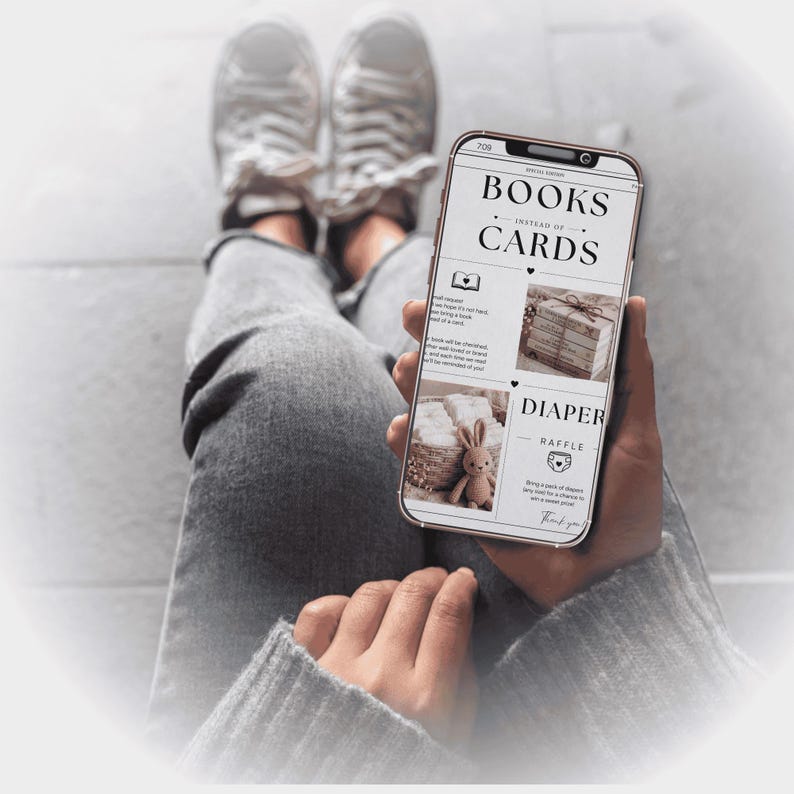 May include: A person holding a smartphone displaying a newspaper-style graphic with the headline "BOOKS INSTEAD OF CARDS." The screen also shows images of books, a stuffed bunny, and text about a diaper raffle. The person is wearing gray jeans and sneakers.
