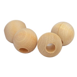 May include: Four natural wood beads with a hole through the center. The beads are round and smooth.