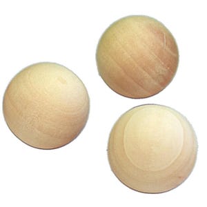 May include: Three smooth, unfinished wooden spheres with a light tan color and visible natural wood grain patterns. Each sphere is perfectly round and exhibits a matte texture, showcasing the raw, unpainted surface of the natural wood material.