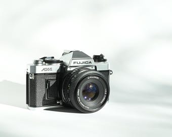 FUJICA フジカ AX-1 & X-FUJINON 55mm F2.2 Fujica AX-1 Camera | X-Fujinon 55mm f2.2 lens | White
