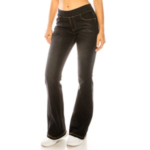 May include: Black denim jeans with a wide leg and a slight flare at the bottom. The jeans have a waistband with a gold stitching detail.