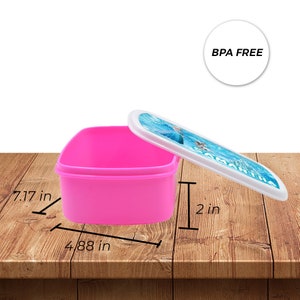 May include: Pink plastic lunch box with a white lid featuring a Frozen character design. The lunch box is 7.17 inches long, 4.88 inches wide, and 2 inches tall. BPA free.