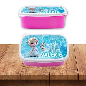 May include: Pink plastic lunchbox with a white lid featuring a Frozen themed design with Elsa, Olaf, and a castle. The name "VALERIE" is printed on the lid.