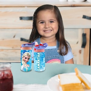 Puede incluir: Dos botellas de agua azules y rosas con un dise&ntilde;o de personaje de Frozen. Una botella tiene el nombre Samantha.