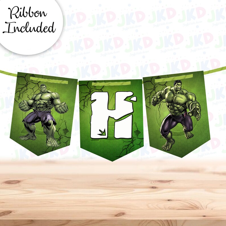May include: Green and white banner with the letter "H" and images of the Hulk. The banner is made of paper and has a green background with a cracked pattern. The Hulk is depicted in a green and purple costume, with his arms outstretched. The banner is strung together with a green ribbon.