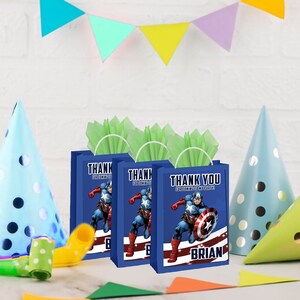 May include: Three blue gift bags with green tissue paper inside. Each bag features a cartoon image of Captain America and the text "Thank You for coming to my party". The bag on the right has the name "Brian" printed on it.