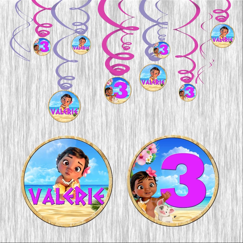 May include: A set of 10 Moana-themed party decorations. The decorations feature a pink and purple swirl design with images of Moana and the number 3. The decorations also include the name "Valerie" printed on them.