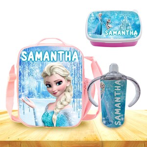 May include: A pink lunch bag with a Frozen theme featuring Elsa, a matching lunchbox with a pink lid, and a clear water bottle with a handle. All items have the name Samantha printed on them.