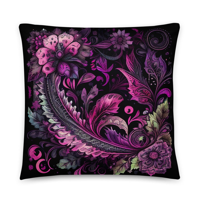 May include: A black pillow with a pink and purple floral pattern. The design features intricate swirls and leaves.