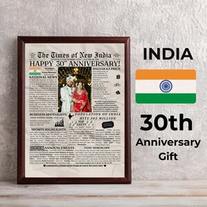 May include: A framed print celebrating a 30th anniversary, featuring a newspaper-style design with the headline "The Times of New India." The print includes a photo of a couple, the Indian flag, and the text "30th Anniversary Gift."