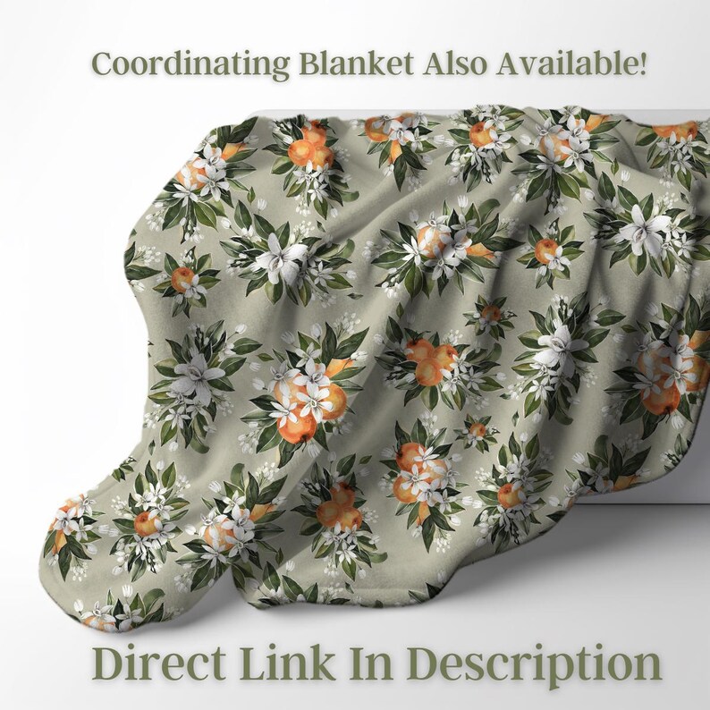 May include: A soft, floral blanket with a repeating pattern of orange fruit and white flowers with green leaves on a light green background. The text "Coordinating Blanket Also Available!" and "Direct Link In Description" are visible.