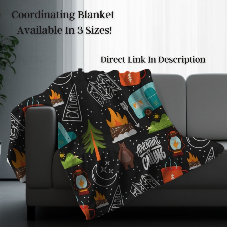 May include: A black blanket with a camping theme, featuring illustrations of campfires, trees, a bear, and a camper. The blanket has the text "Adventure is Calling" and "Explore". Available in 3 sizes.