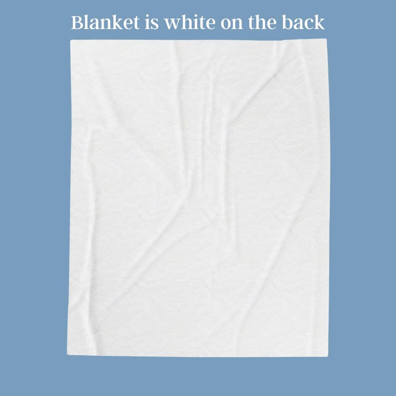 May include: A white blanket with a textured surface is displayed against a blue background. The text "Blanket is white on the back" is at the top. The blanket is folded and has visible creases.