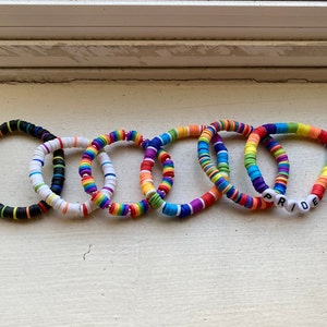 May include: Six colorful beaded bracelets, including one with the word "PRIDE" spelled out in white beads.