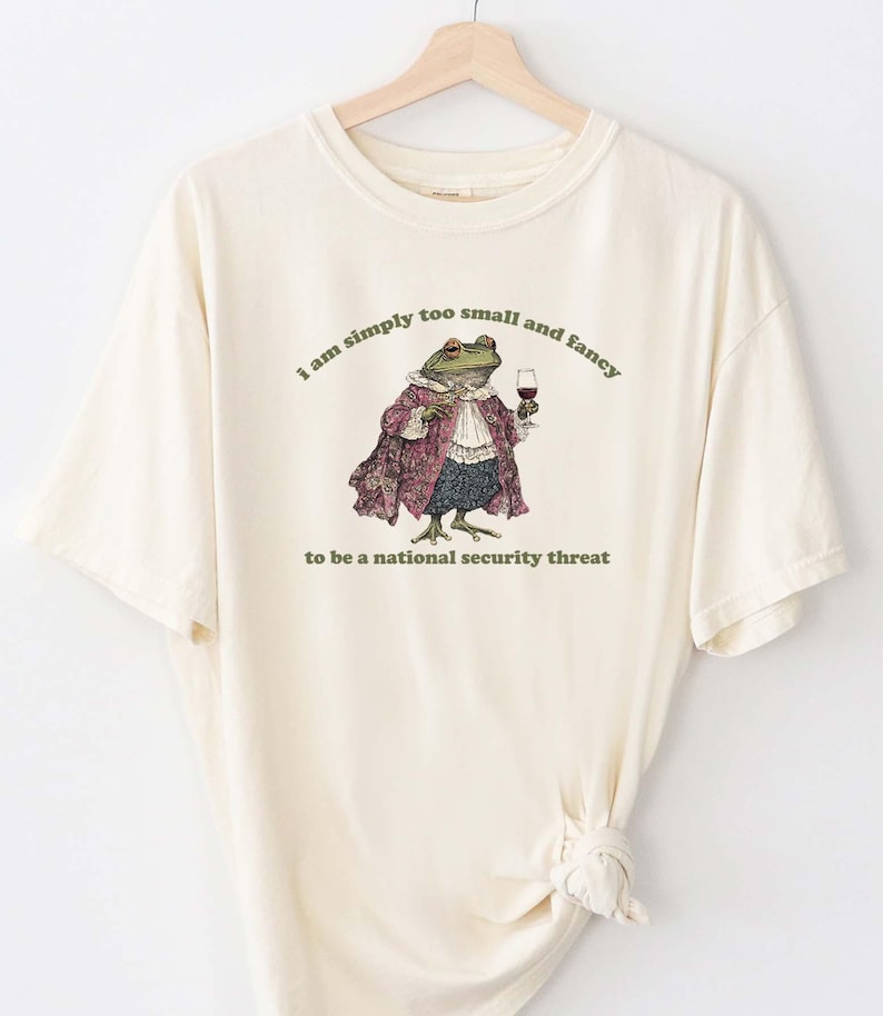A shirt with a fancy frog that says I am simply too small and fancy to be a national security thread.