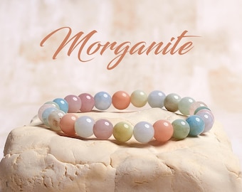 May include: A pastel-colored beaded bracelet made of morganite gemstones. The bracelet is made of light pink, light blue, and light green beads.