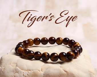 May include: Tiger's Eye bracelet made with brown and gold beads.
