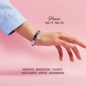 May include: A Pisces gemstone bracelet featuring amethyst, moonstone, fluorite, rose quartz, apatite, and aquamarine beads. The bracelet is displayed on a wrist against a pink background. Text on the image reads "Pisces Feb 19 - Mar 20".