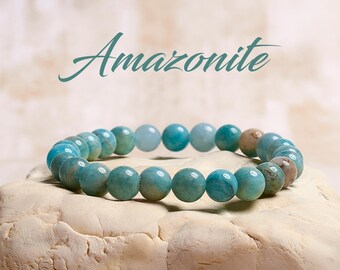 May include: A blue and green Amazonite gemstone bracelet. The bracelet is made of round beads and is strung on a clear elastic cord.