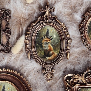 May include: Five decorative wall frames in various shapes and sizes, each featuring an ornate bronze-colored border. Inside every frame is an illustration of a fox wearing a pointed witch hat, set against a dark, starry forest background.