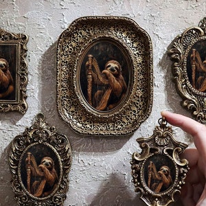 May include: Five ornate gold frames with intricate details, each containing a painting of a sloth playing a harp. The frames are arranged on a textured wall.