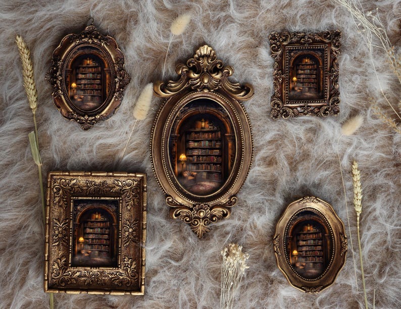 May include: A collection of five ornate, antique-style frames in various shapes, including oval and rectangular, with a warm gold finish. Each frame contains a miniature diorama of a library interior with bookshelves and soft lighting, creating a cozy, vintage aesthetic.
