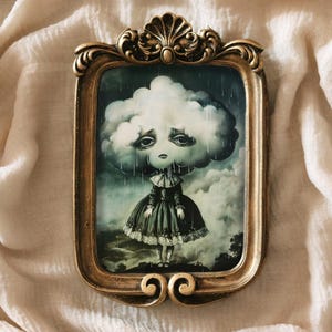 May include: A framed illustration of a sad-looking cloud with a face and raindrops falling from it. The cloud is wearing a dress and standing in a field.