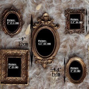 May include: An assortment of antique-style picture frames in various shapes and sizes. The frames are gold and bronze-toned, with ornate detailing. The largest frame is approximately 9 inches (22 cm) tall, while the smallest is about 4 inches (10 cm) tall.