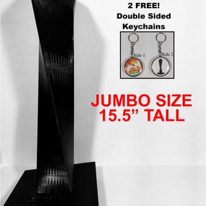 May include: Black, 15.5 inch tall, 3D printed model of a skyscraper with a square base. The model comes with two free double-sided keychains. One keychain features a colorful image of a bird with the word "Evolution" printed on it. The other keychain features a black silhouette of a skyscraper.
