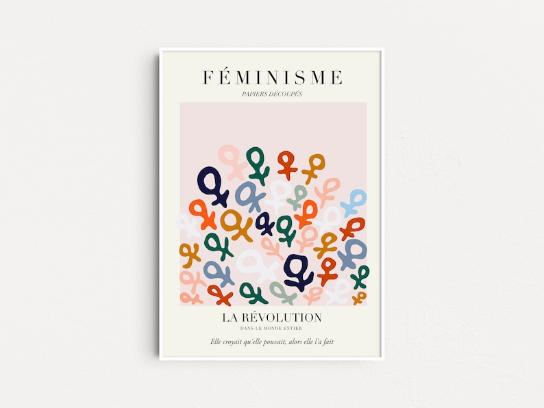 May include: A pink poster with the text "F&Eacute;MINISME" and "PAPIERS D&Eacute;COUP&Eacute;S" in black. The poster features a cluster of colorful female symbols in a variety of colors, including blue, green, orange, and red. The text "LA R&Eacute;VOLUTION" and "DANS LE MONDE ENTIER" is in black at the bottom of the poster. The text "Elle croyait qu'elle pousait, alors elle l'a fait" is in black at the bottom of the poster.