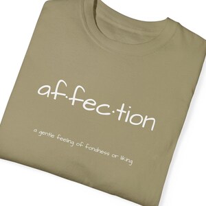May include: A khaki t-shirt with the word "af.fection" printed in white. The text is defined as "a gentle feeling of fondness or liking".