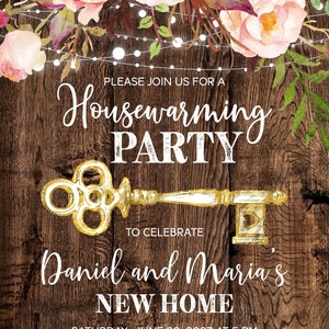 May include: A rustic wooden background with a gold key and floral garland. The text reads "Please join us for a Housewarming Party to celebrate Daniel and Maria's New Home. Saturday, June 20, 2023 at 5 PM. 321 Lake Street, New York, NY 43434. RSVP to Maria at 123-456-7890."