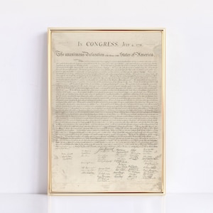May include: A framed print of the Declaration of Independence, a historical document signed by the founding fathers of the United States. The document is written in cursive script and includes the date "July 4, 1776".