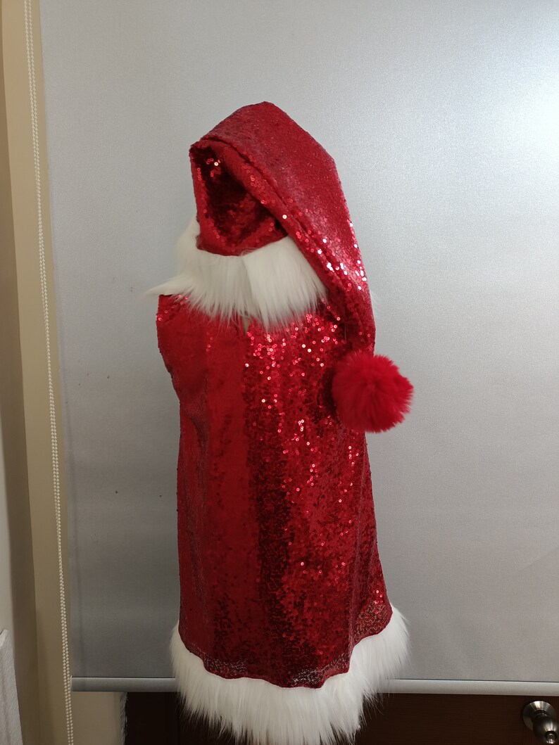 May include: Red sequined Santa suit with a white fur trim and a red pom-pom on the hat.