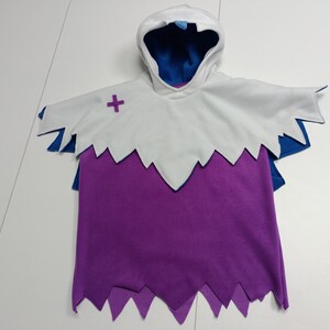 May include: A hooded costume in white, purple, and blue. The costume has a white hood with a blue interior, a white cape with a purple cross, and a purple body with a jagged hemline. The costume is designed to look like a ghost.