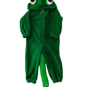 May include: Green plush chameleon costume for a child. The costume features a hood with large eyes and a tail.