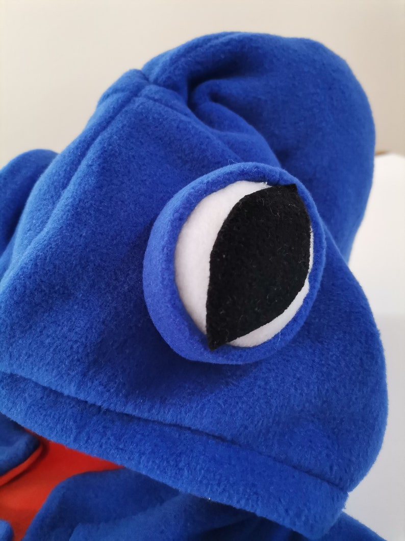 May include: Blue fleece hooded costume with a large white eye with a black pupil.