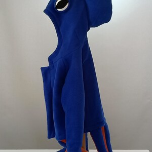 May include: Blue fleece octopus costume with a large eye on the hood and orange tentacles.