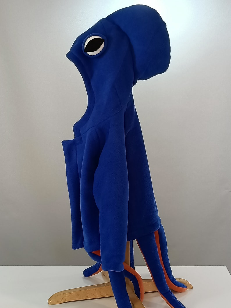 May include: Blue fleece octopus costume with a large eye on the hood and orange tentacles.