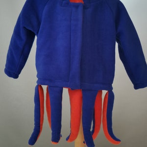 May include: Blue and orange octopus costume for a child. The costume has a blue hooded sweatshirt with long sleeves and orange tentacles.