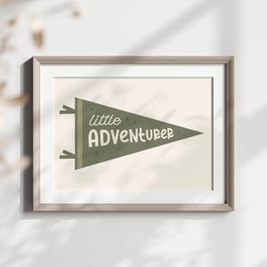 May include: A framed print with a green pennant design that says "little adventurer" in white lettering.
